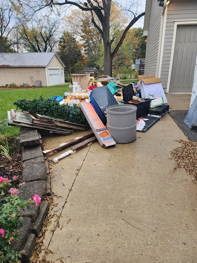 Dumpster being loaded with debris for 12 Yard Dumpster Rental in Marshall